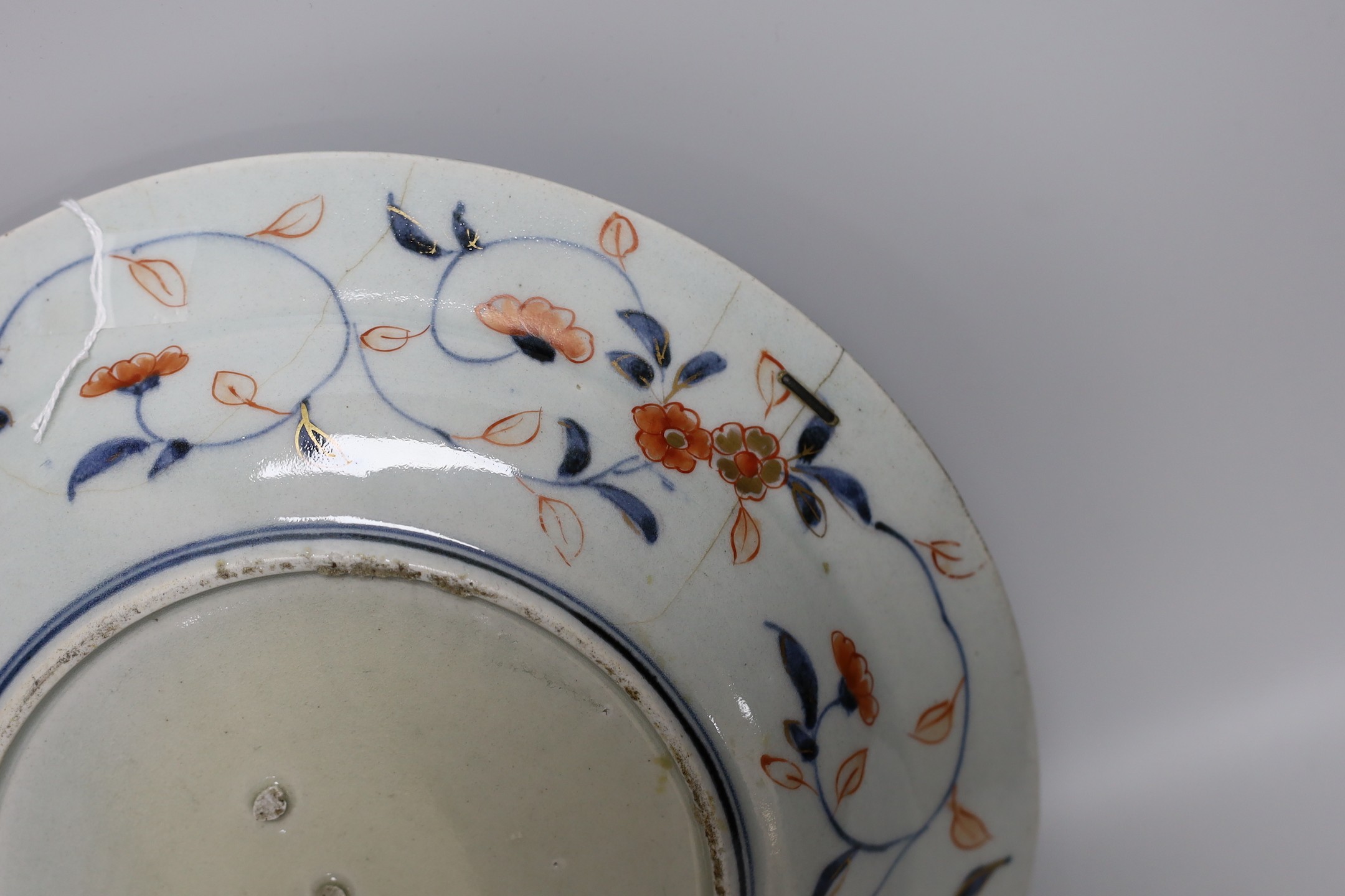 A Japanese Arita dish, late 17th century, painted in Imari palette, stilt marks, cracked, 28cms diameter